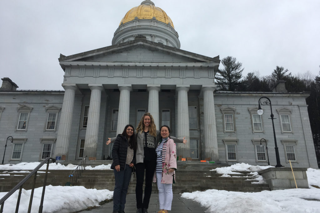 Three women standing in front of the state house in Montpelier Vermont