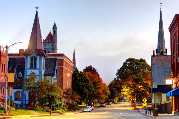 A paved main road with buildings lining the street in St. Johnsbury, Vermont