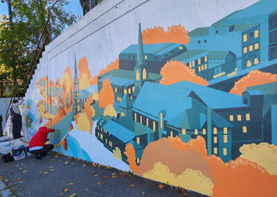 Local Artist painting High Street Mural in Brattleboro, VT