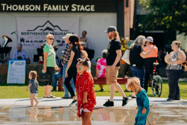 Children splashing and having fun in front of the Thomson Family Stage